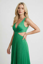 Elegant green pleated maxi dress by Lumina Wear featuring flowing design and sophisticated style.