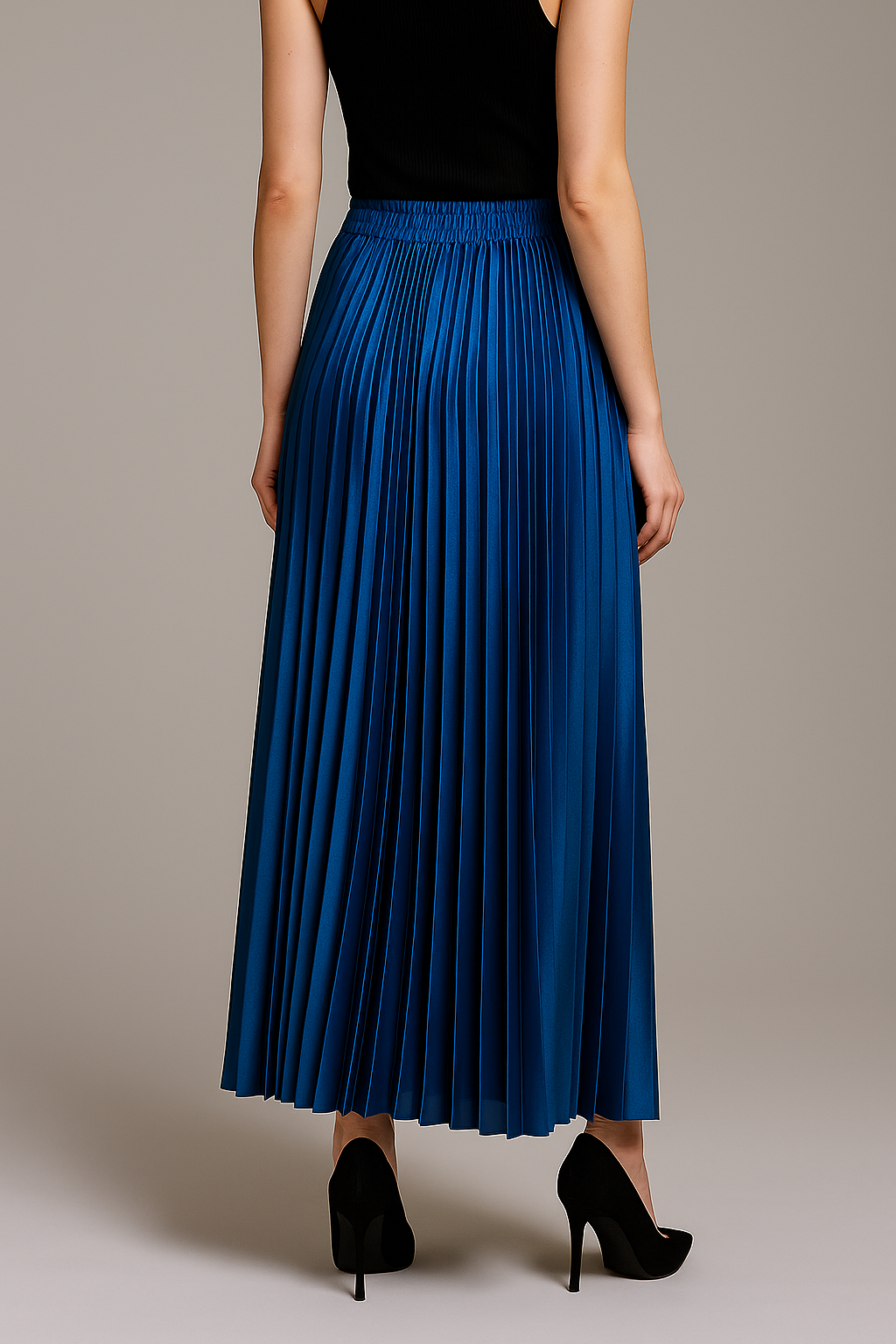 Gold high waist pleated maxi skirt from Lumina Wear, styled with flowing fabric and elegant pleats.