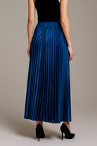 Gold high waist pleated maxi skirt from Lumina Wear, styled with flowing fabric and elegant pleats.