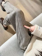 Gray high-waisted pencil trousers by Lumina Wear, styled for a sleek, elegant look in this image.