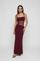 Elegant burgundy lace bodycon dress with spaghetti straps from Lumina Wear, designed for women, shown on a mannequin.