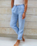 Lightweight beige linen trousers from Lumina Wear's Isabella collection, tailored pants with a sleek, elegant fit.