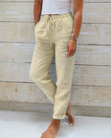 Lightweight beige linen trousers from Lumina Wear, model Isabella, stylish and elegant pants with a relaxed fit and natural fabric texture.