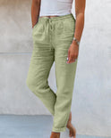 Lightweight beige linen trousers by Lumina Wear, styled on a model, showcasing elegant and comfortable pants for casual or dressy wear.