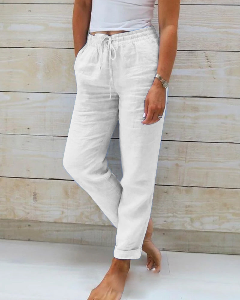Lightweight beige linen trousers from Lumina Wear, model Isabella, featuring a relaxed fit and elegant design.