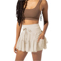 Light brown Isabella Lumina Wear pleated mini skirt with integrated shorts, stylish and elegant for casual or dressy outfits.