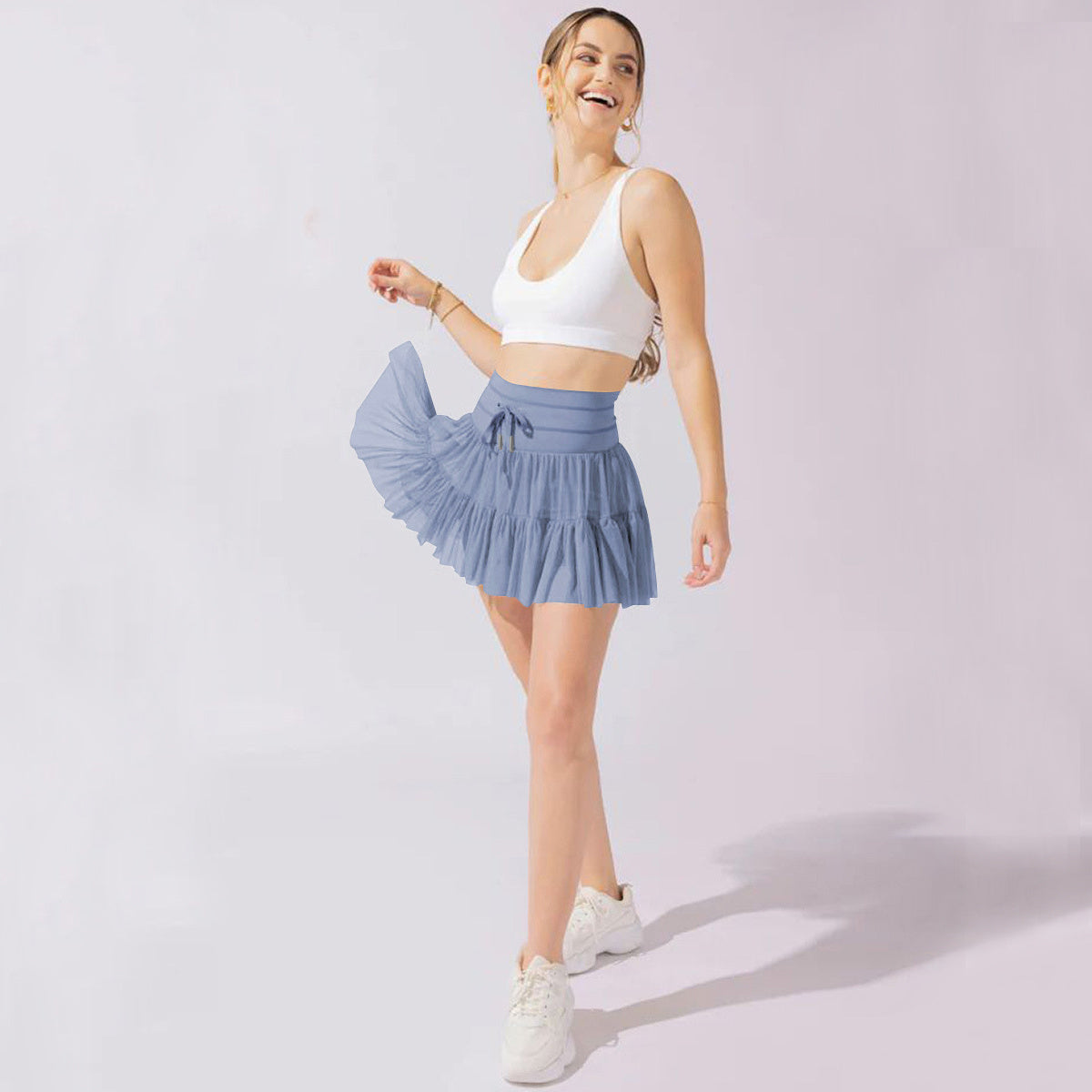 Light brown Isabella pleated mini skirt with integrated shorts from Lumina Wear, featuring a stylish, elegant design.