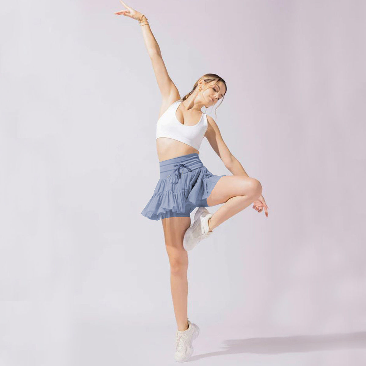Light brown Isabella Lumina Wear pleated mini skirt with integrated shorts, stylish and elegant for casual or dressy outfits.