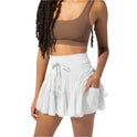 Light brown Isabella pleated mini skirt with integrated shorts by Lumina Wear, stylish and comfortable for casual or dressy looks.