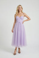 Elegant purple Lumina Wear midi dress with flattering silhouette, showcasing smooth fabric and stylish design.