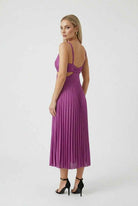 Elegant purple pleated wedding guest dress with fluid drape from Lumina Wear, featuring a stylish and sophisticated design.