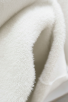 Elegant white turtleneck sweater by Lumina Wear featuring a slim fit and cozy design, perfect for stylish winter outfits.
