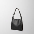 Brown Isabella Lumina structured leather shoulder bag with spacious interior, stylish design, and elegant craftsmanship.