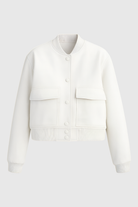 White Isabella bomber jacket by Lumina Wear featuring a sleek, timeless design and elegant fit in a close-up image.