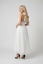 Elegant white midi dress by Lumina Wear featuring a flattering silhouette and stylish design for women's dresses.