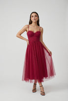 Elegant wine red midi dress by Lumina Wear, featuring a versatile cut and fitted silhouette for women.