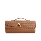 Elegant woven brown Lumina handbag with adjustable strap, featuring a stylish design and top handles.