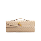 Elegant woven brown Lumina handbag with adjustable strap, showcasing its stylish design and craftsmanship.