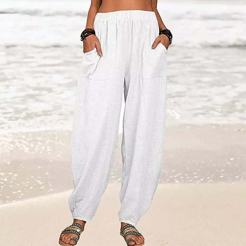 High-waisted black harem trousers from Lumina Wear featuring a casual fit and relaxed style, shown in white in the image.