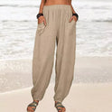 Isabella Lumina high-waisted black harem trousers with a casual fit, featuring a relaxed, comfortable design and white accents.