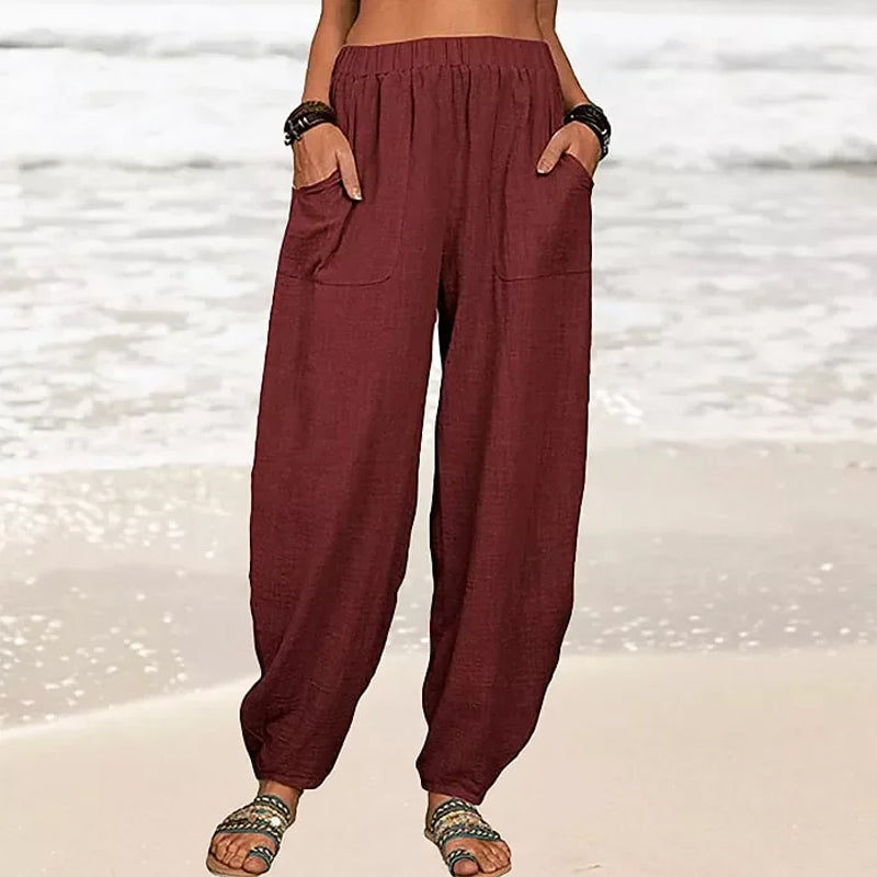 Isabella high-waisted black harem trousers by Lumina Wear with a casual fit and relaxed style, shown in a white background image.