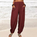 Isabella Lumina high-waisted black harem trousers with casual fit, featuring relaxed style and tapered legs.