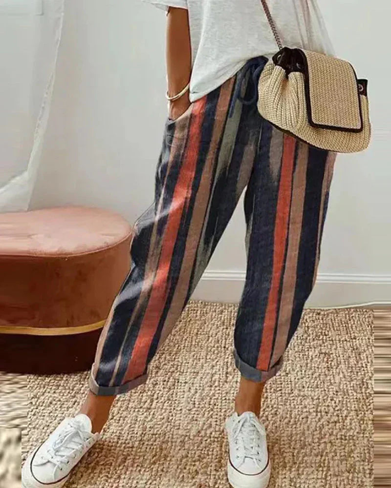 Isabella Lumina Wear grey linen trousers showing a lightweight, breathable fabric, relaxed fit, and modern design.