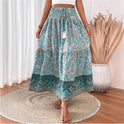 Lightweight floral maxi skirt with layered design by Lumina Wear, featuring a green pattern and flowing fabric.