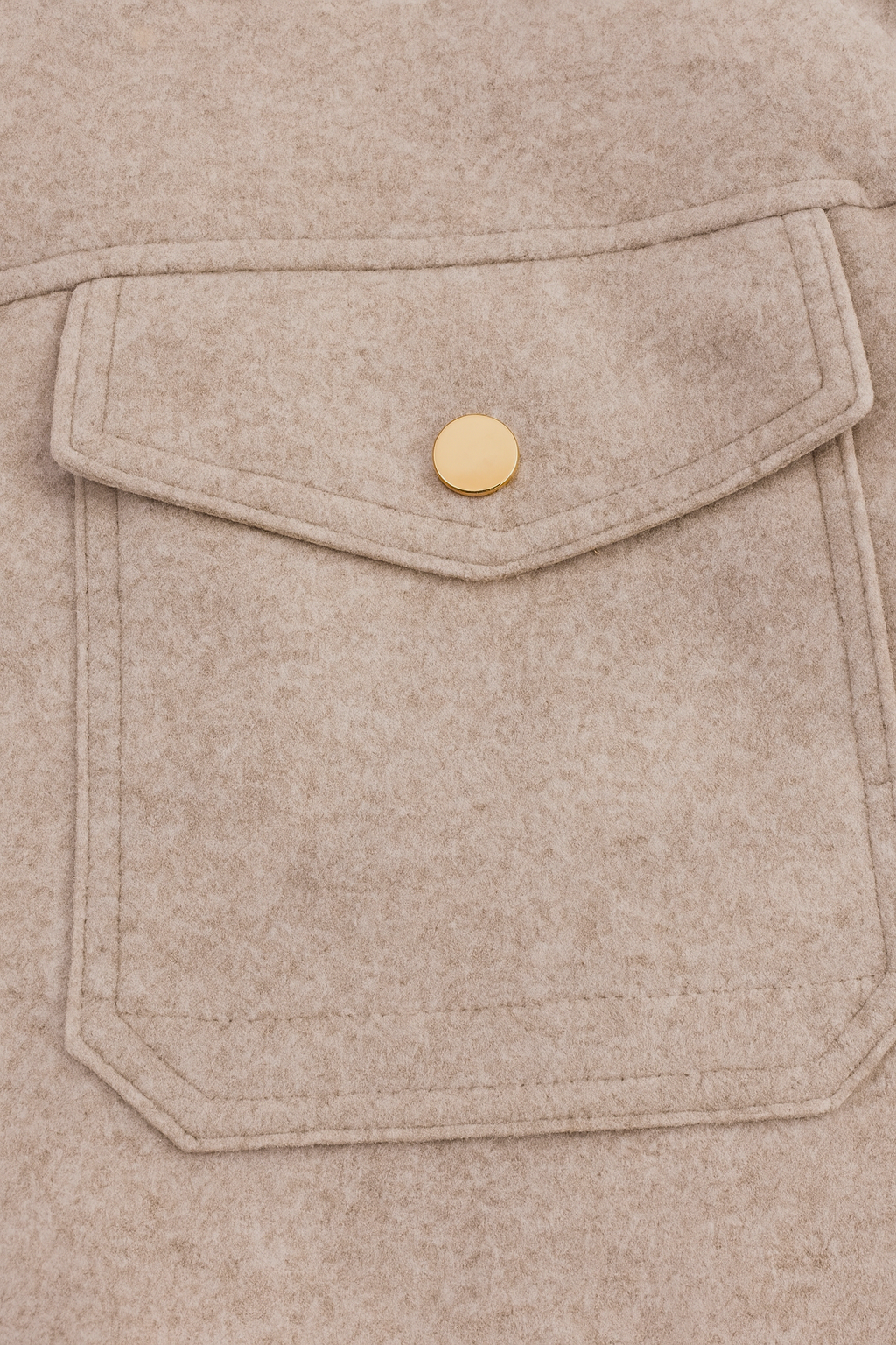 Beige Isabella Lumina Wear modern cropped zip-up jacket with pockets, displayed on a model in a casual outdoor setting.