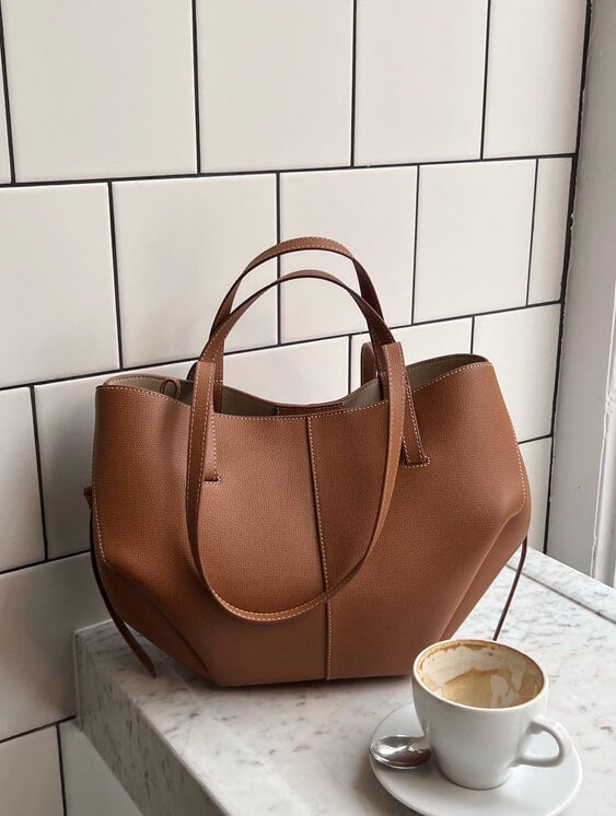 Lumina Wear Isabella oversized vintage handbag with versatile straps, brown leather, and spacious interior for stylish everyday use.