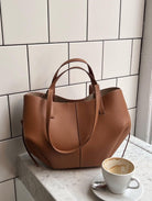 Lumina Wear Isabella oversized vintage handbag with versatile straps, brown leather, and spacious interior for stylish everyday use.