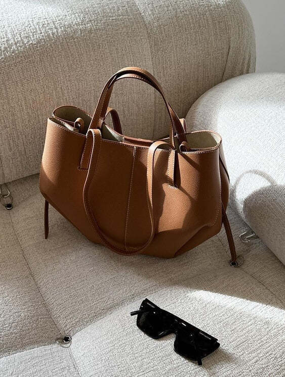 Brown oversized vintage handbag with versatile straps by Lumina Wear, featuring textured leather and spacious interior.