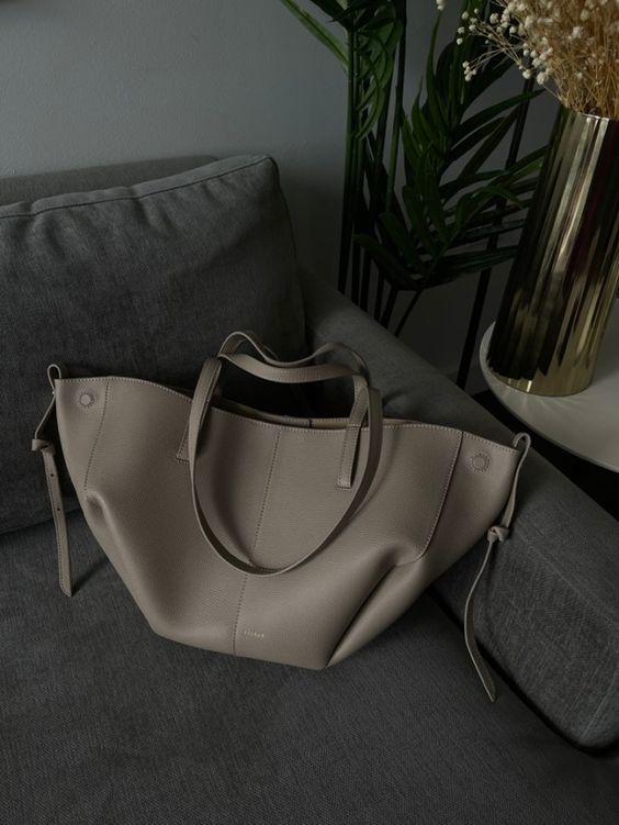 Brown oversized vintage handbag with versatile straps from Lumina Wear, featuring textured leather and spacious interior.