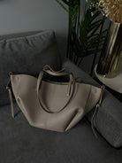 Brown oversized vintage handbag with versatile straps from Lumina Wear, featuring textured leather and spacious interior.