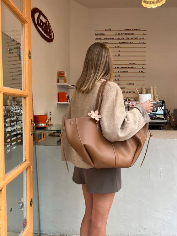 Brown oversized vintage handbag with versatile straps by Lumina Wear, featuring textured leather and spacious interior.