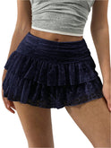 White ruffled mini skirt with wide waistband from Lumina Wear, featuring playful design and a fitted silhouette.
