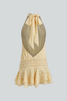 Isabella Lumina yellow mini dress with playful fit, casual style, feminine silhouette, worn by a model in a bright outdoor setting.