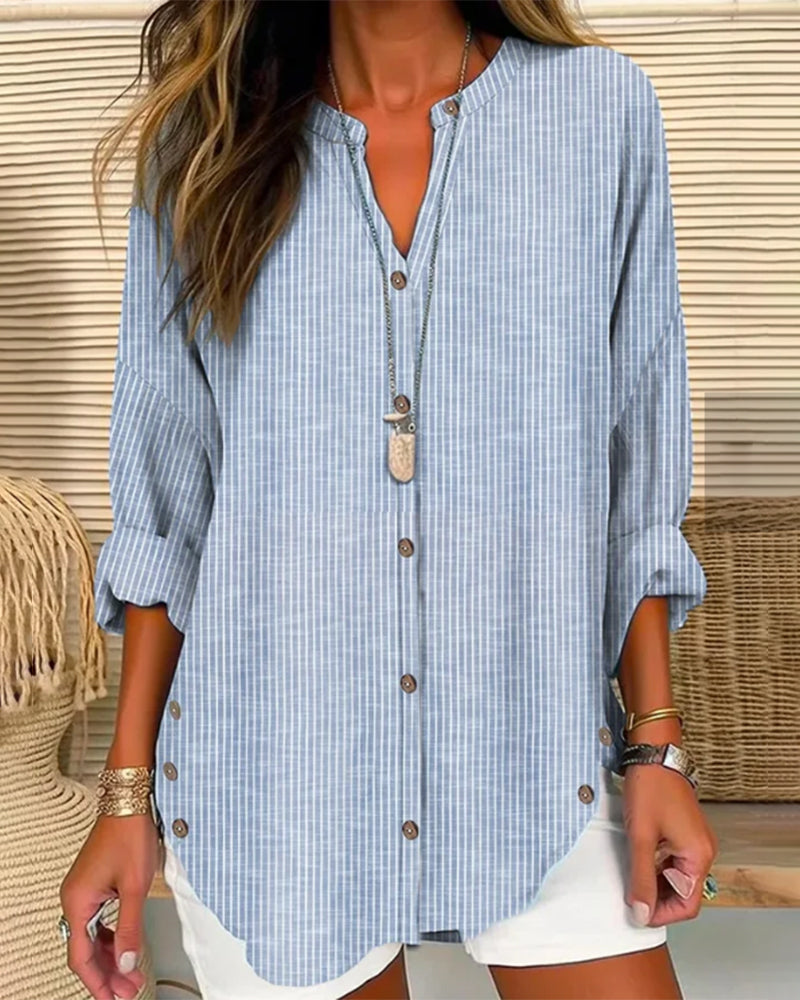 Blue Isabella relaxed striped blouse with button front by Lumina Wear, displayed on a hanger.