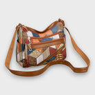 Isabella textured patchwork shoulder handbag with faux-leather accents by Lumina Wear, featuring multiple fabric patterns and a shoulder strap.