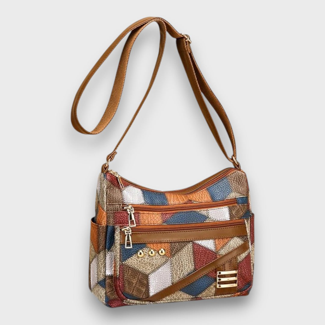 Lumina Wear Isabella textured patchwork shoulder bag with faux-leather accents, featuring a stylish and spacious handbag design.