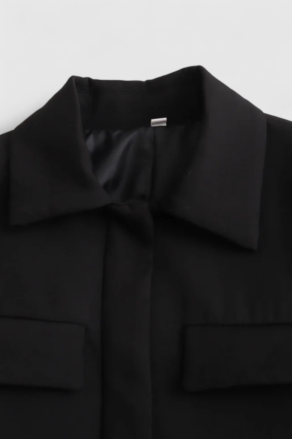 Black Isabella Lumina women's cropped jacket with a tailored fit, displayed on a model showcasing the stylish design.