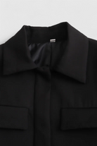 Black Isabella Lumina women's cropped jacket with a tailored fit, displayed on a model showcasing the stylish design.