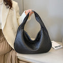 Beige Isabella Lumina woven eco-leather shoulder handbag with unique design and shoulder strap, stylish and eco-friendly fashion accessory.