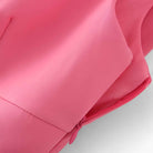 Vibrant pink cami top with playful bow detail from Lumina Wear, featuring a sleeveless design and lightweight fabric.