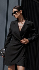 Isabelle classic black trench dress by Lumina Vancouver, stylish mini dress with trench-inspired design, displayed on a model.