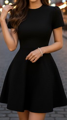 Black Isabelle high neck belted dress by Lumina Vancouver, featuring a fitted silhouette and stylish waist belt.