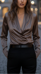 Brown Isabelle lace-up blouse by Lumina Vancouver displayed on a hanger with detailed fabric and stylish design.