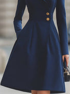 Navy blue Isabelle Lumina Vancouver tailored fit flared midi coat dress with peak lapel, shown on a model.