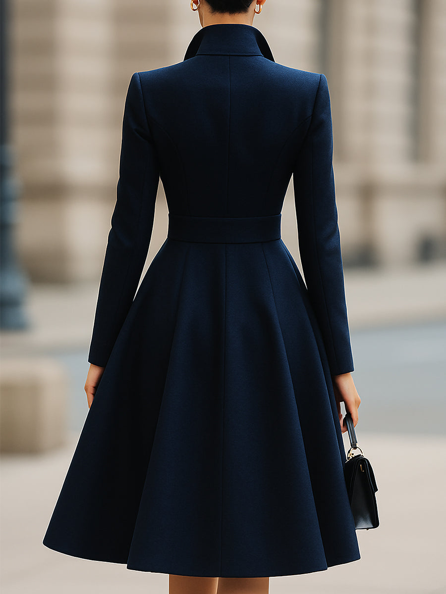 Navy blue Isabelle Lumina Vancouver tailored fit flared midi coat dress with peak lapel, displayed on a model.