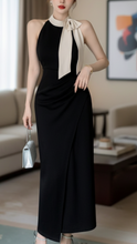 Black Isla halter neck midi dress by Lumina Wear, shown on a model, featuring a sleek, stylish design perfect for elegant occasions.